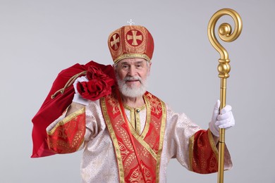 Photo of Saint Nicholas with sack on light grey background