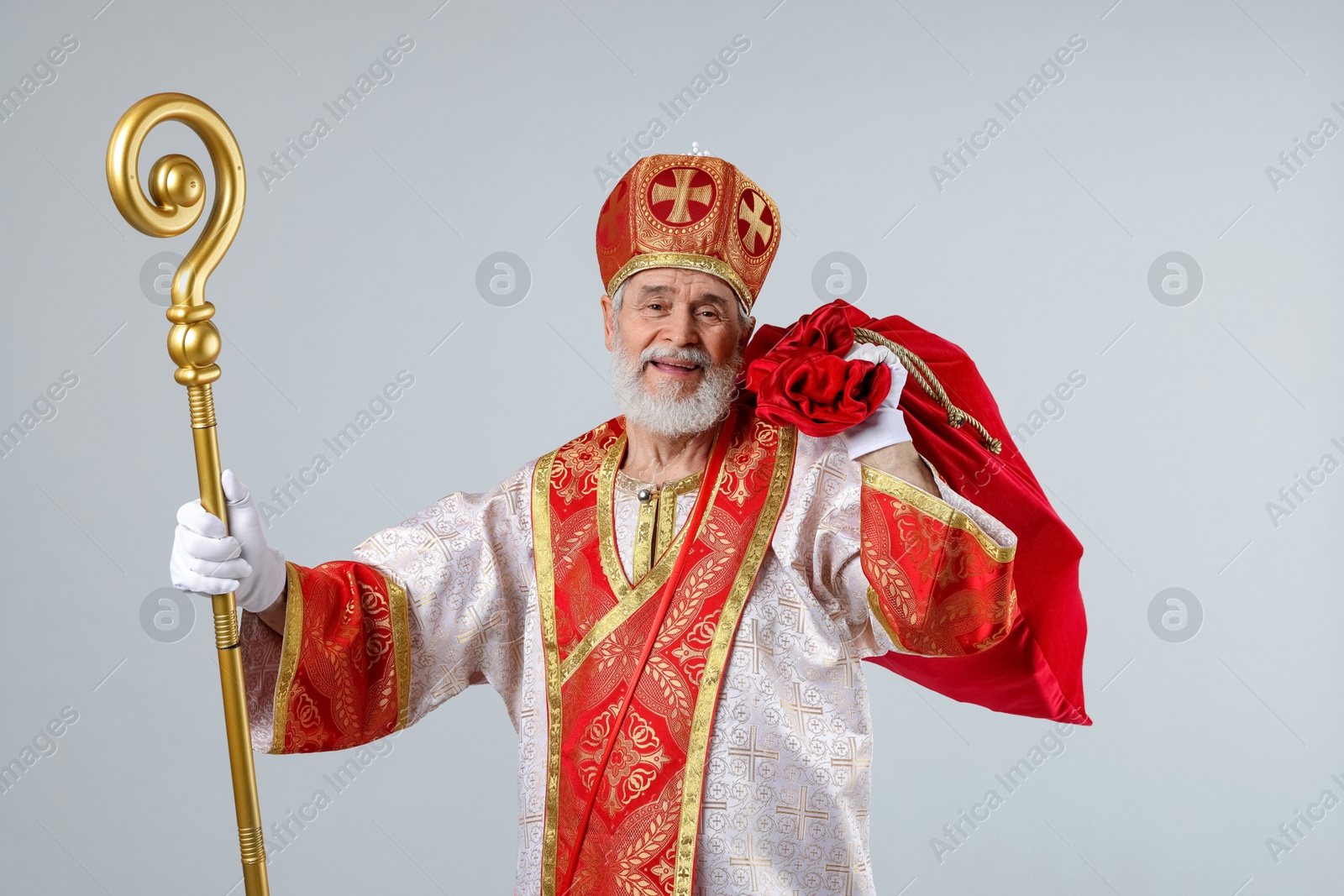 Photo of Saint Nicholas with sack on light grey background