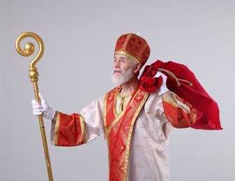 Photo of Saint Nicholas with sack on light grey background