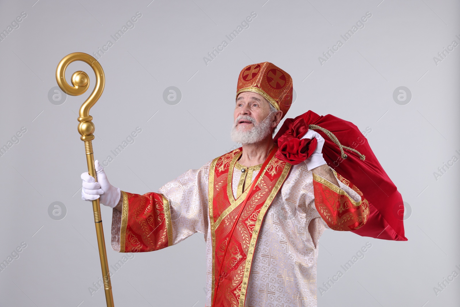 Photo of Saint Nicholas with sack on light grey background