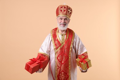 Photo of Saint Nicholas with gifts on beige background