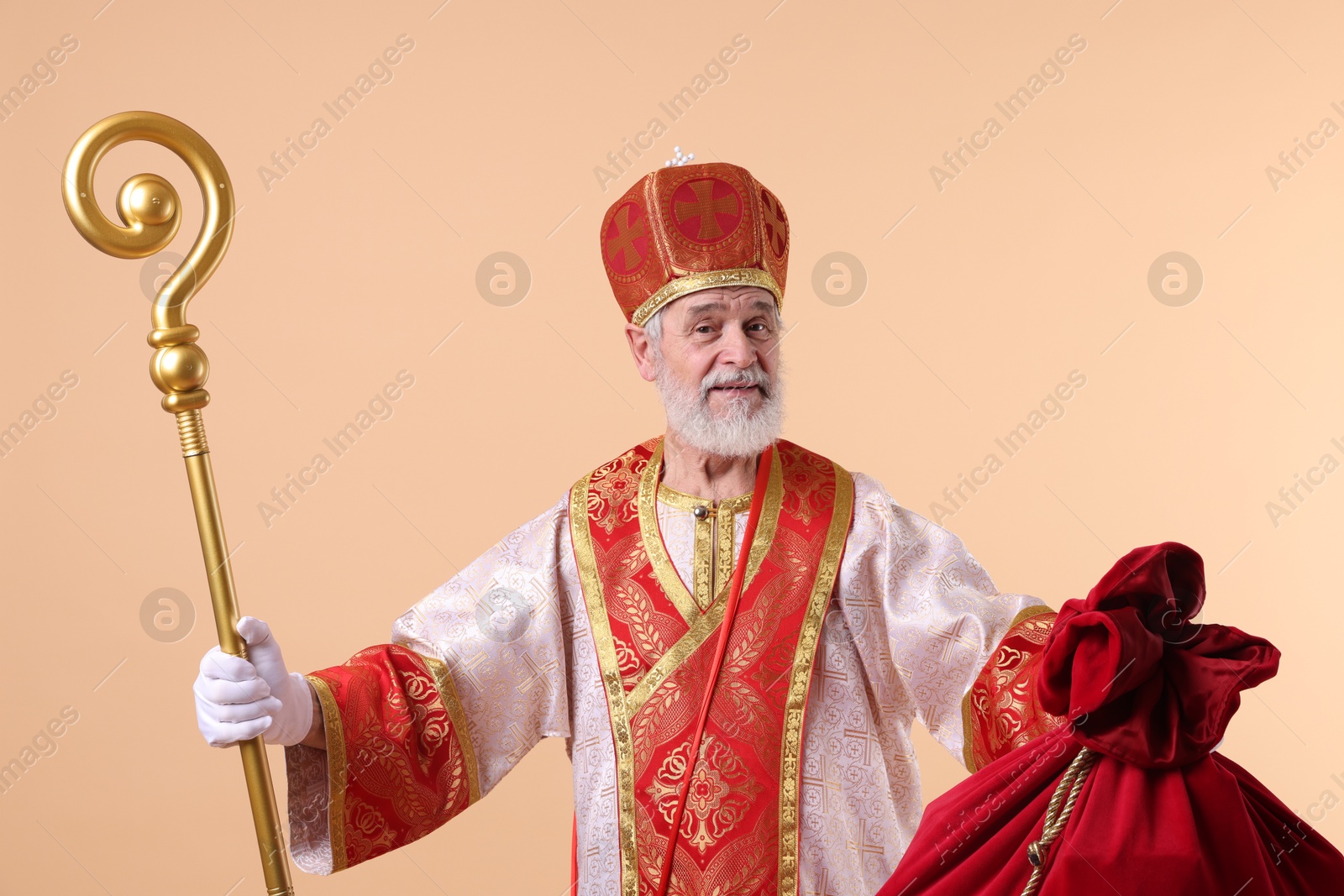 Photo of Saint Nicholas with sack on beige background