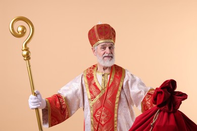 Photo of Saint Nicholas with sack on beige background