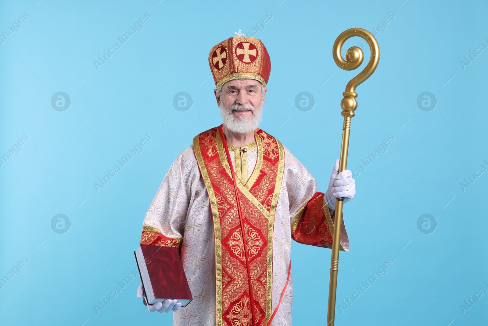 Photo of Saint Nicholas with book on light blue background