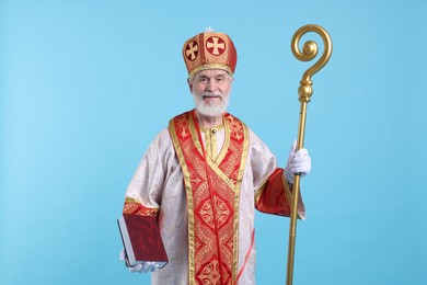 Saint Nicholas with book on light blue background