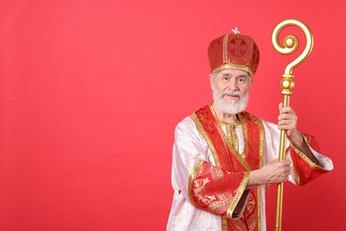 Photo of Saint Nicholas with crozier on red background. Space for text