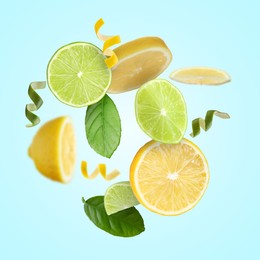 Image of Lemon, lime, zest and green leaves in air on light blue background