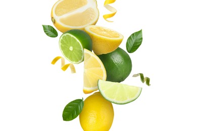 Image of Limes, lemons, zest and green leaves in air on white background