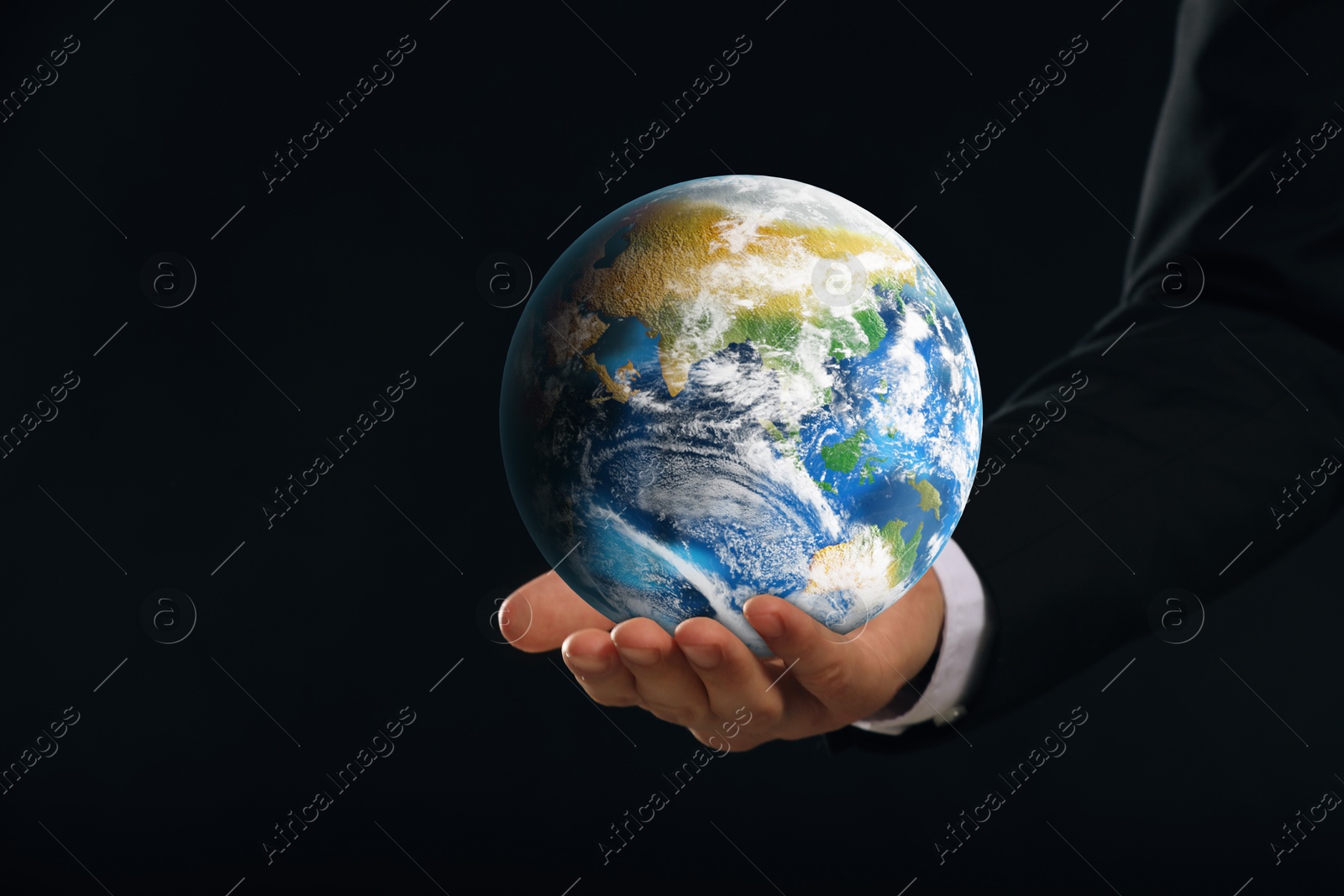 Image of Planet in our hands. Man holding Earth model on black background, closeup