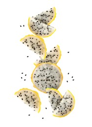 Image of Pieces of tasty yellow pitaya fruit falling on white background