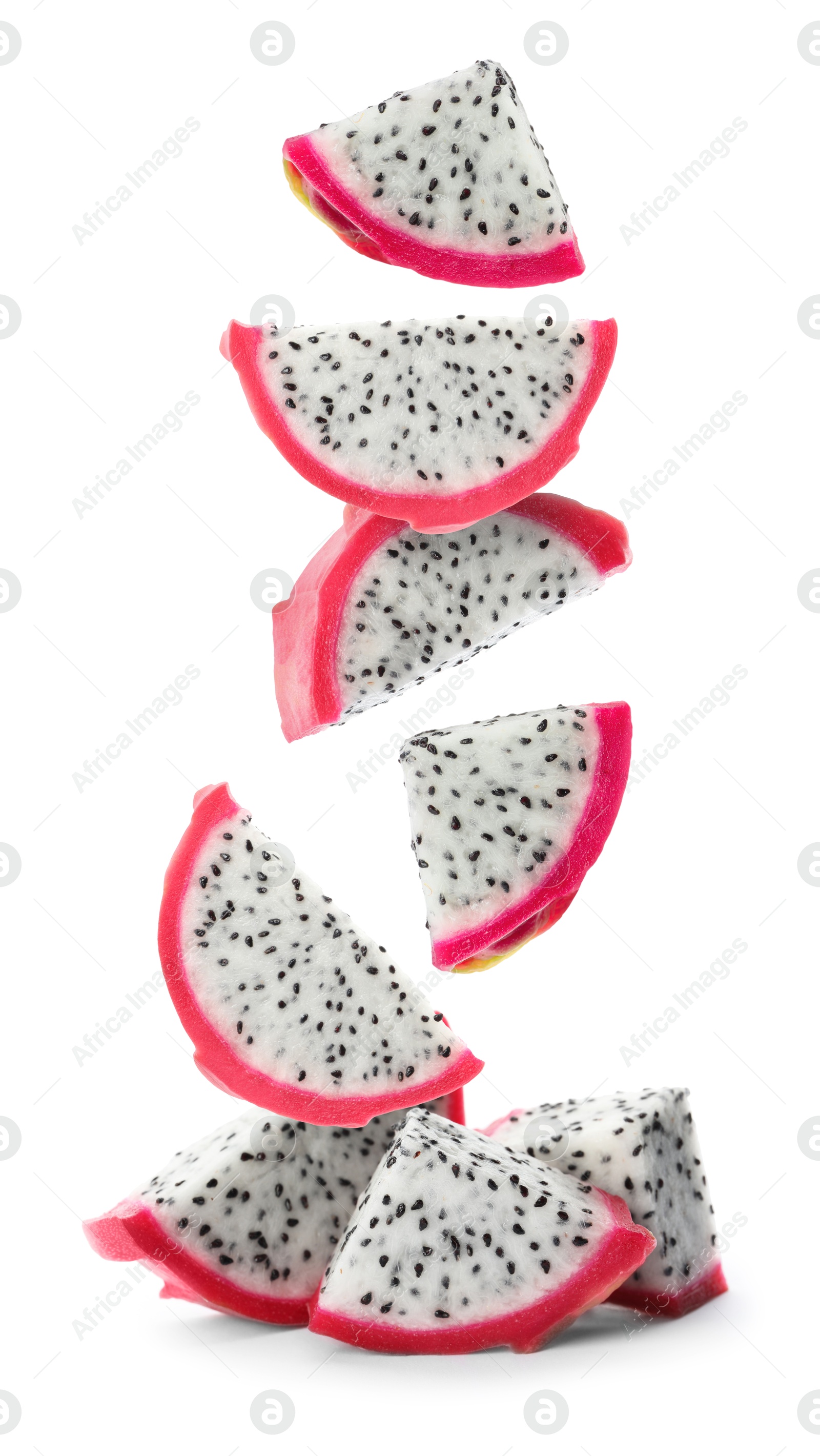 Image of Pieces of tasty pitaya fruit falling on white background