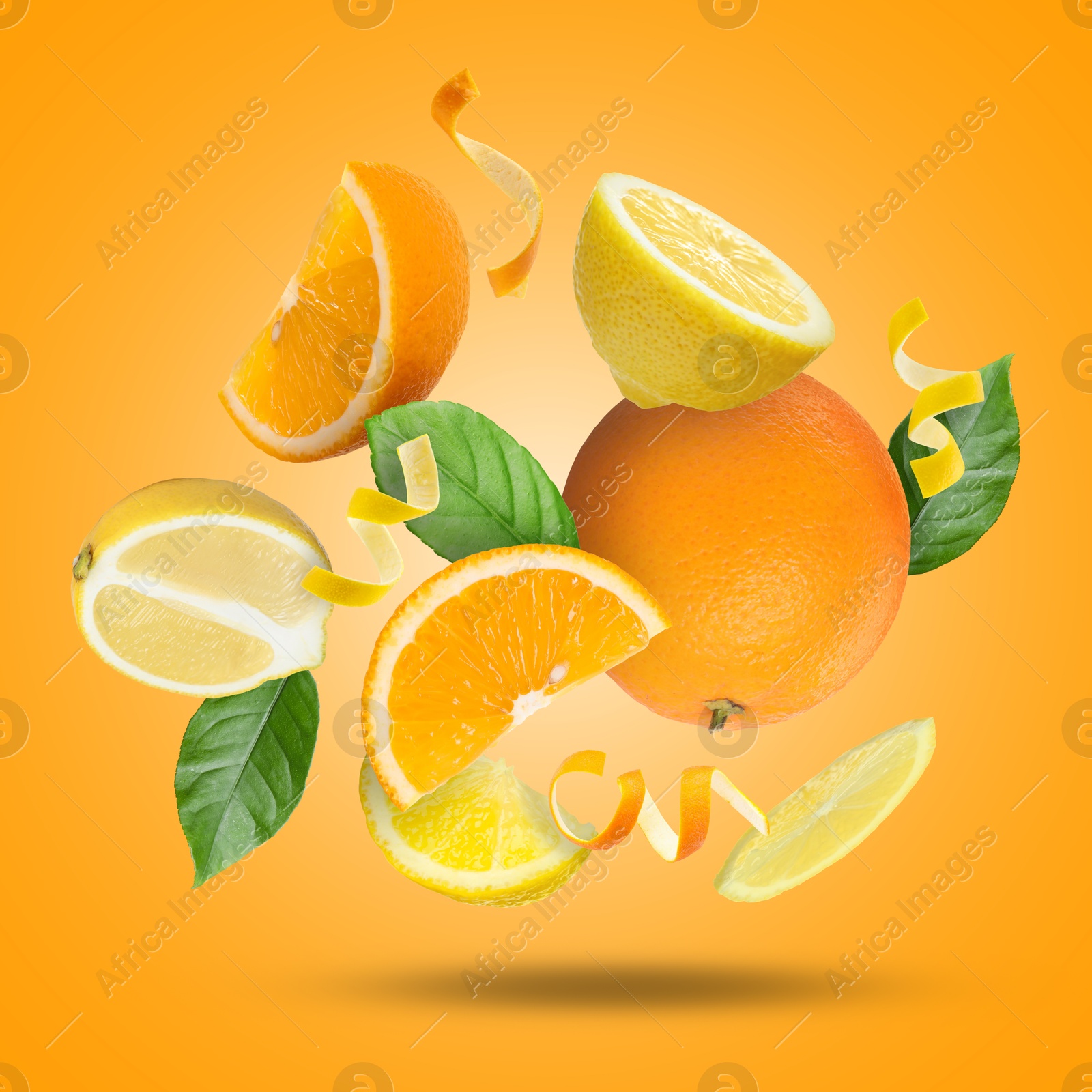 Image of Lemon, orange, zest and green leaves in air on orange background