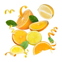 Image of Lemon, orange, zest and green leaves in air on white background