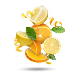 Image of Lemon, orange, zest and green leaves in air on white background