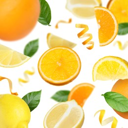 Image of Lemons, oranges, zest and green leaves in air on white background