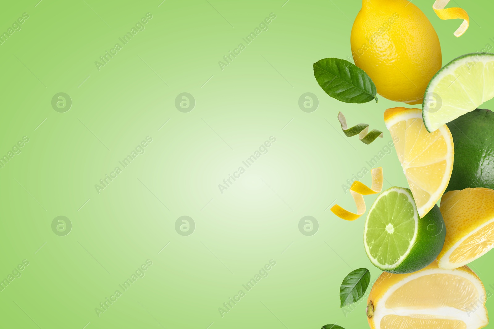 Image of Limes, lemons, zest and leaves in air on light green background