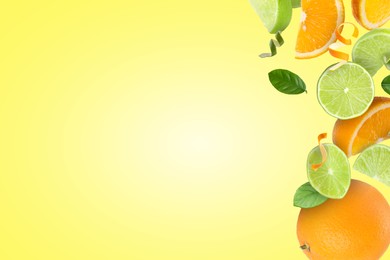 Image of Limes, oranges, zest and green leaves in air on yellow background, space for text