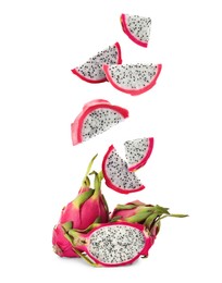 Image of Pieces of tasty pitaya fruit falling on white background