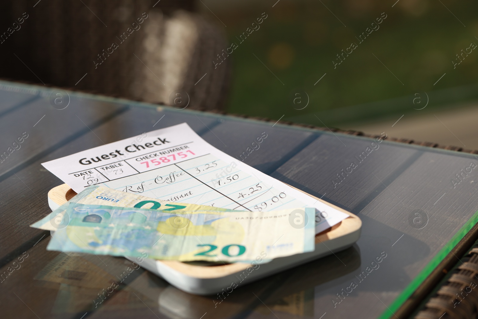 Photo of Wooden plate with payment for order and receipt on table, space for text. Leave tip