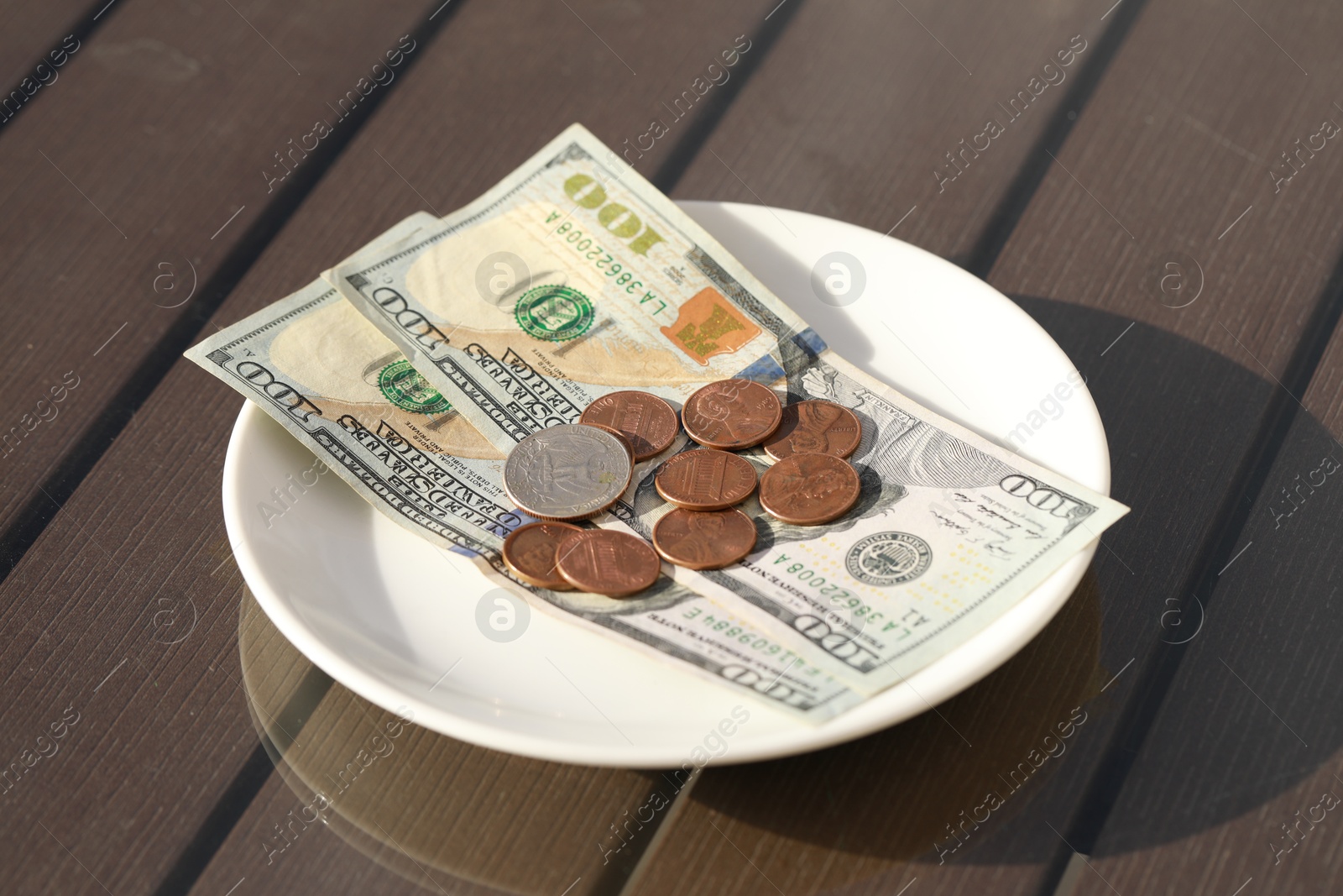 Photo of Saucer with payment for order on table. Leave tip