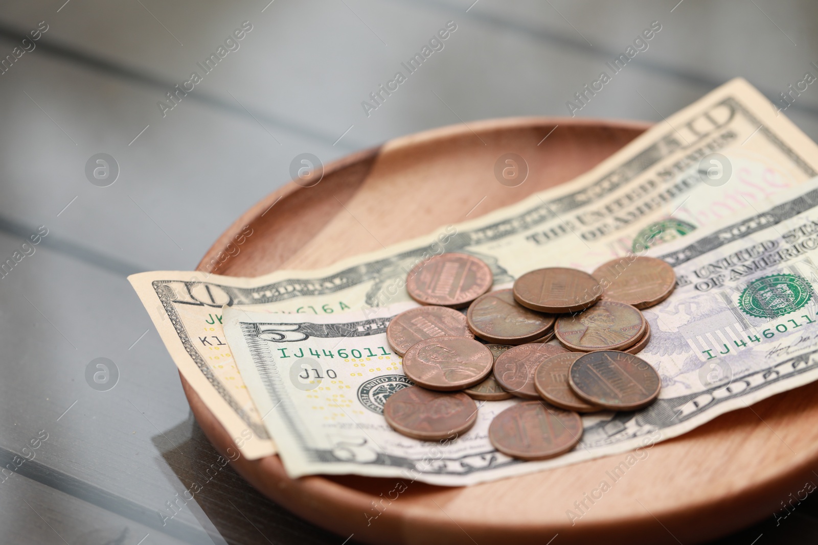 Photo of Tip on wooden table in cafeteria, closeup