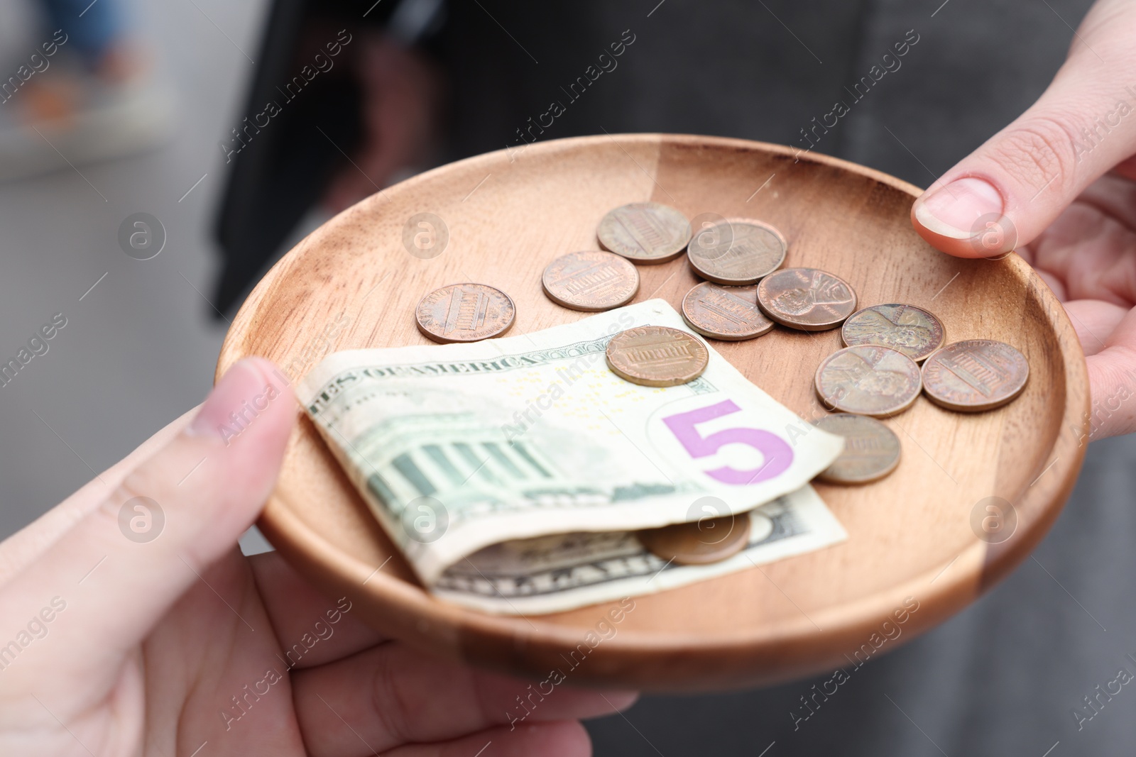 Photo of Client giving tips to waitress in outdoor cafe, closeup