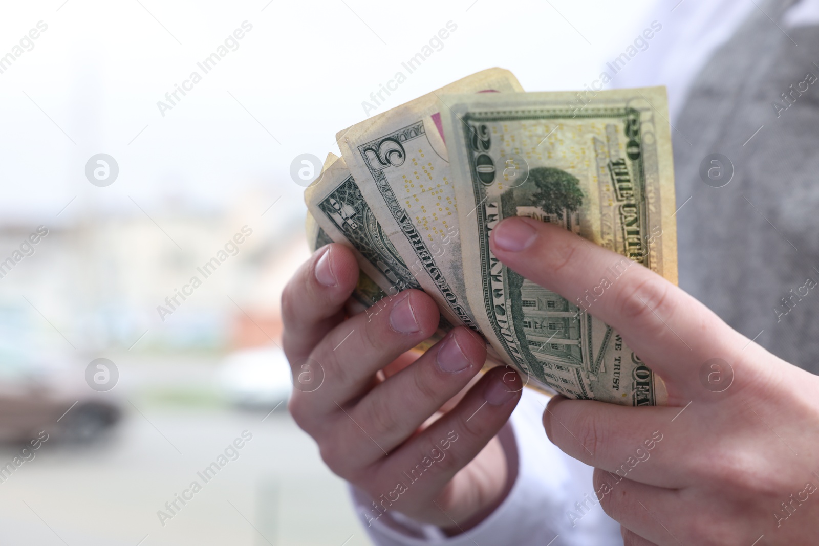 Photo of Waiter holding tips in outdoor cafe, closeup