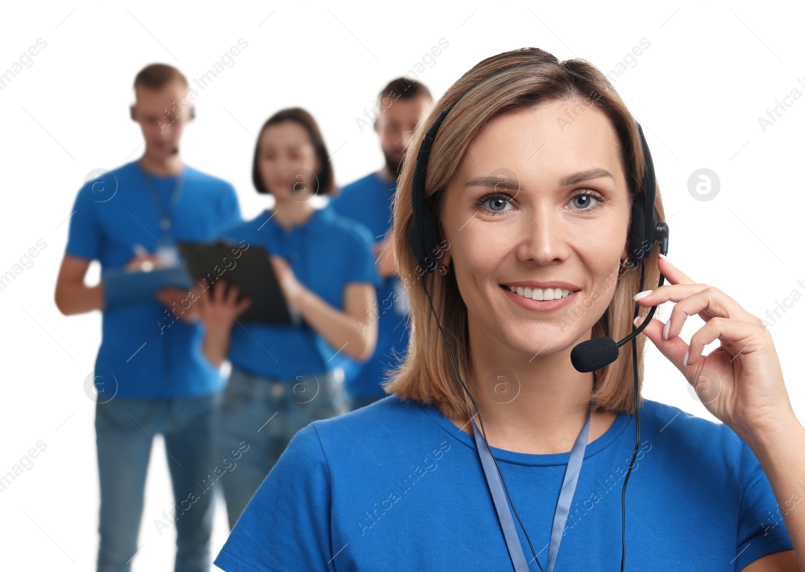 Photo of Technical support call center. Smiling operator on white background, selective focus