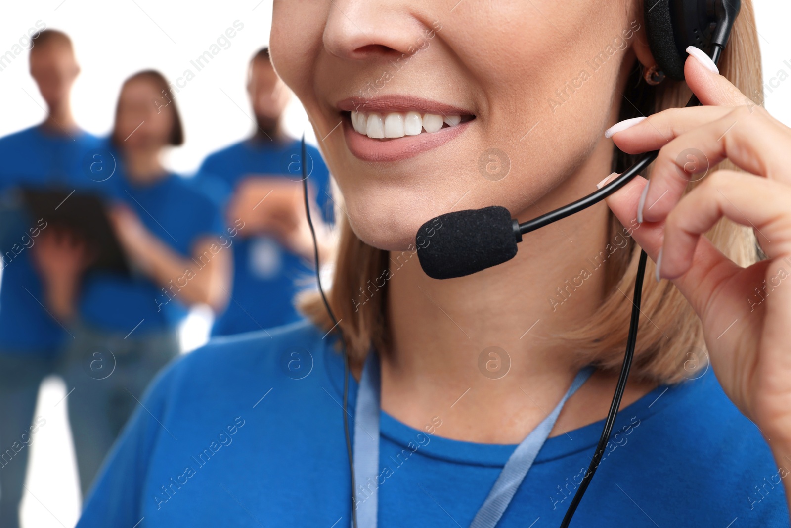 Photo of Technical support call center. Smiling operator on white background, closeup