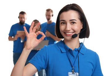 Photo of Technical support call center. Team of friendly operators on white background