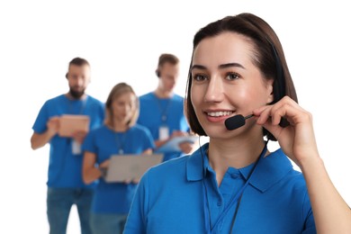 Photo of Technical support call center. Smiling operator on white background, selective focus