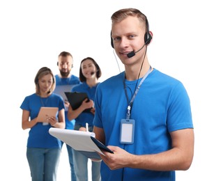 Photo of Technical support call center. Team of friendly operators on white background