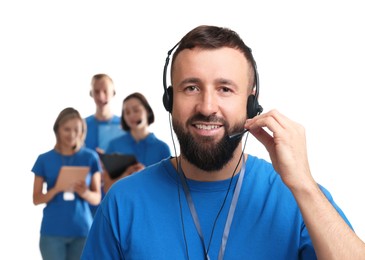 Photo of Technical support call center. Team of friendly operators on white background