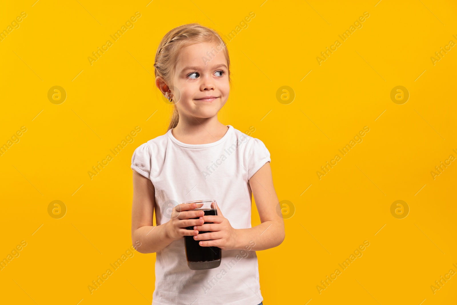 Photo of Girl with glass of refreshing soda drink on orange background