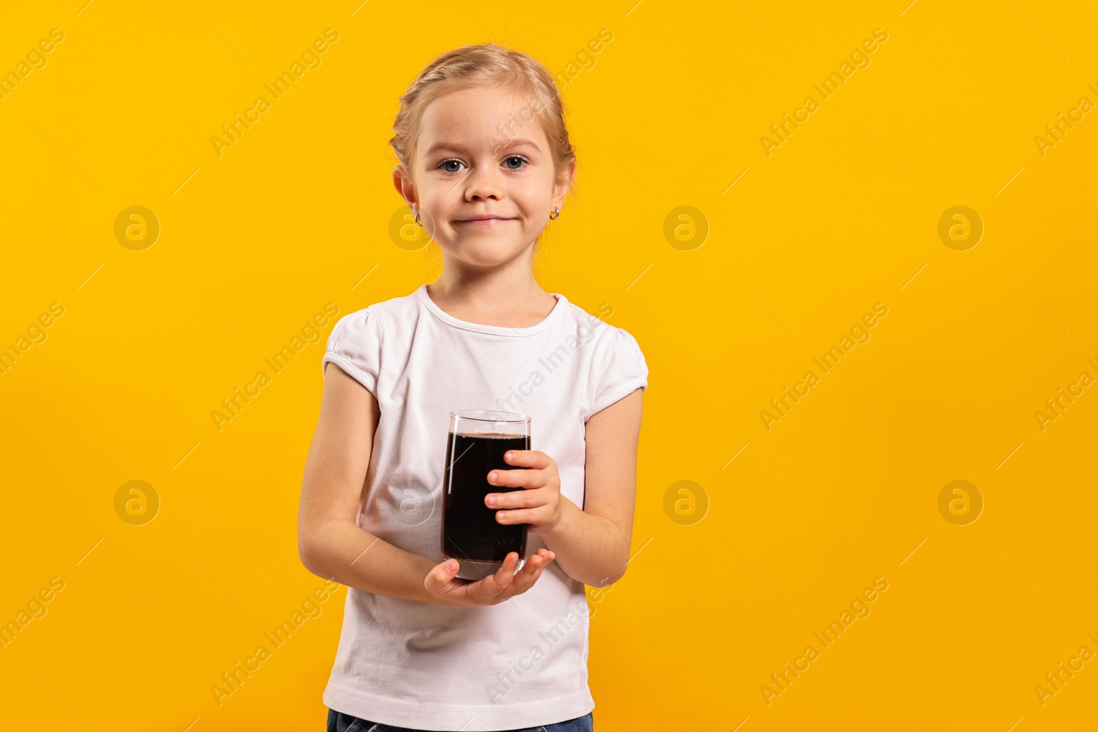 Photo of Girl with glass of refreshing soda drink on orange background