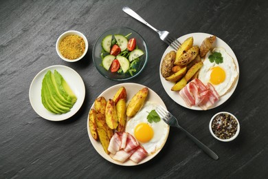 Photo of Flat lay composition with tasty brunch served on dark textured table