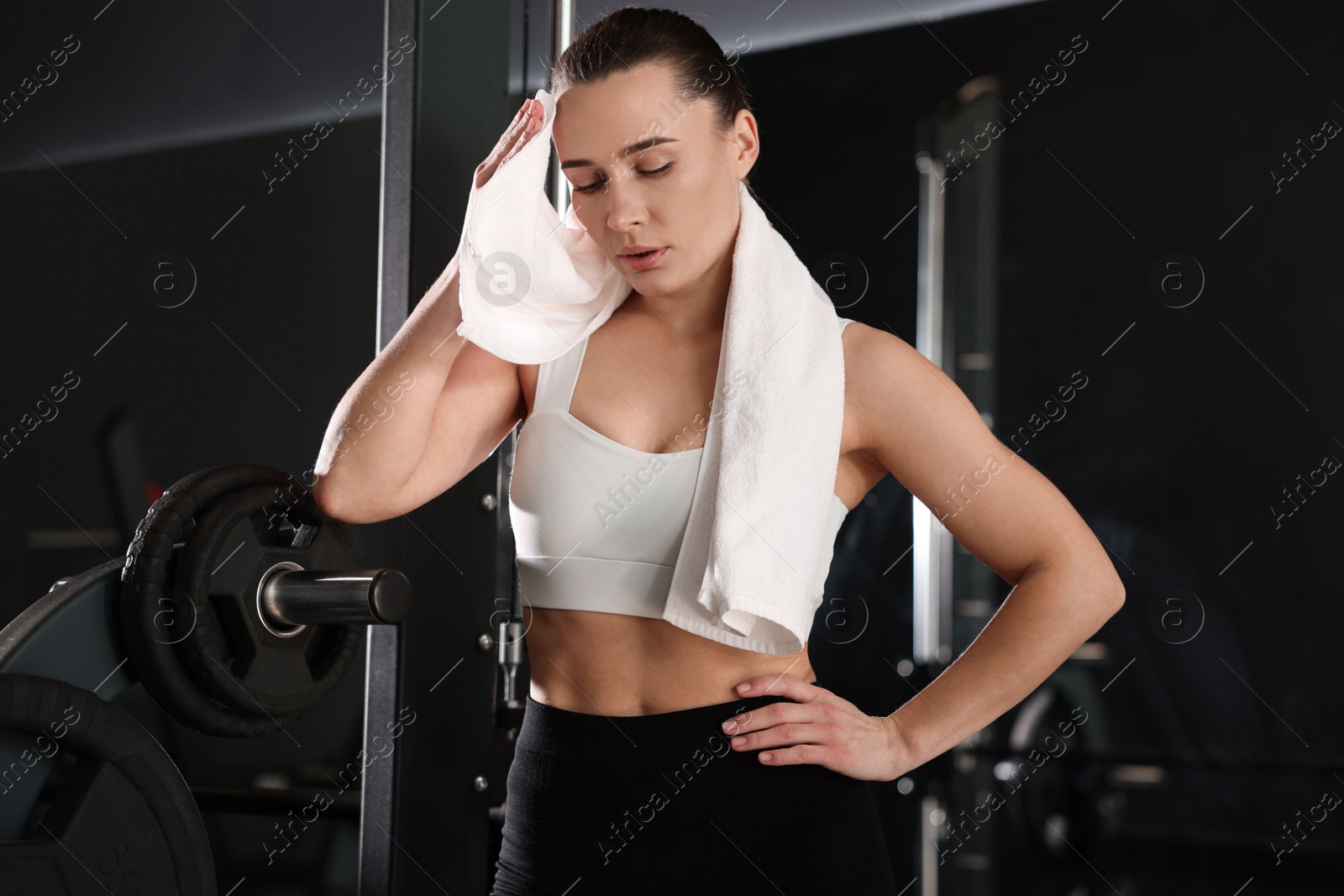 Photo of Beautiful woman with terry towel in gym