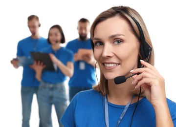 Photo of Technical support call center. Smiling operator on white background, selective focus