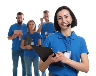 Photo of Technical support call center. Team of friendly operators on white background