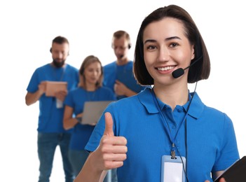 Photo of Technical support call center. Team of friendly operators on white background