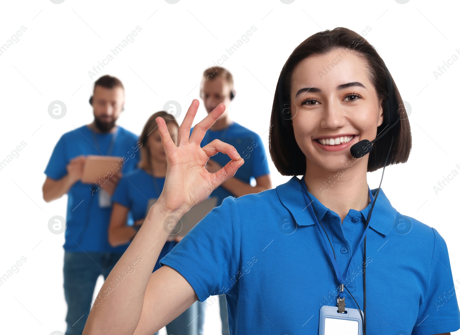 Photo of Technical support call center. Team of friendly operators on white background