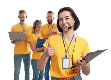 Photo of Technical support call center. Team of friendly operators on white background