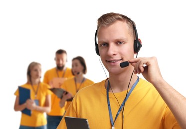 Photo of Technical support call center. Team of friendly operators on white background