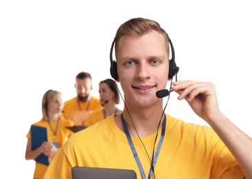 Photo of Technical support call center. Team of friendly operators on white background