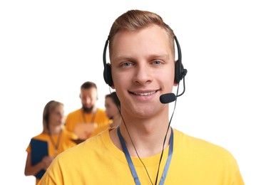 Photo of Technical support call center. Smiling operator on white background, selective focus