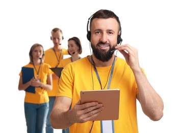 Photo of Technical support call center. Team of friendly operators on white background