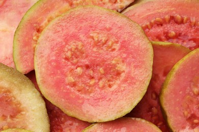 Photo of Many juicy slices of guava as background, closeup