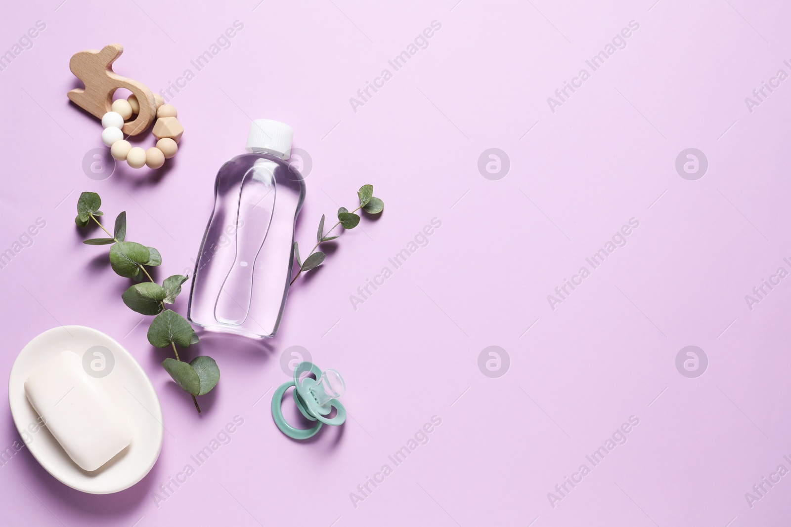 Photo of Baby oil and bath accessories on lilac background, flat lay. Space for text