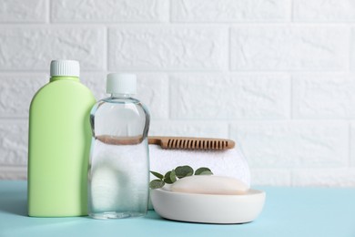 Photo of Baby oil and bath accessories on blue table