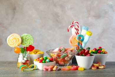 Photo of Candy bar. Many different sweets on wooden table against grey background. Space for text